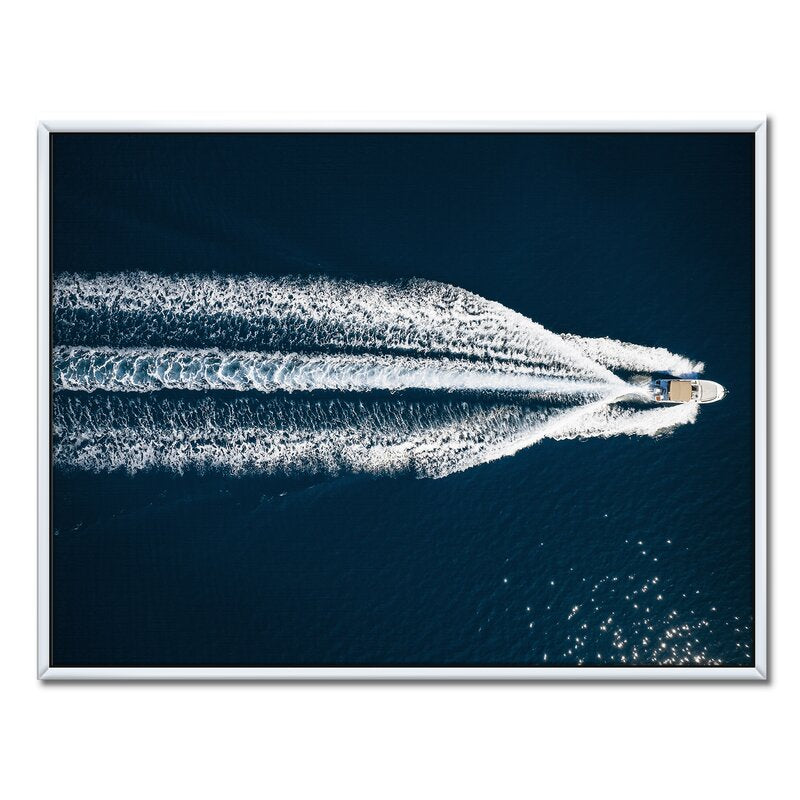 Serene Aerial View of a Speedboat Gliding Across the Mediterranean Waters