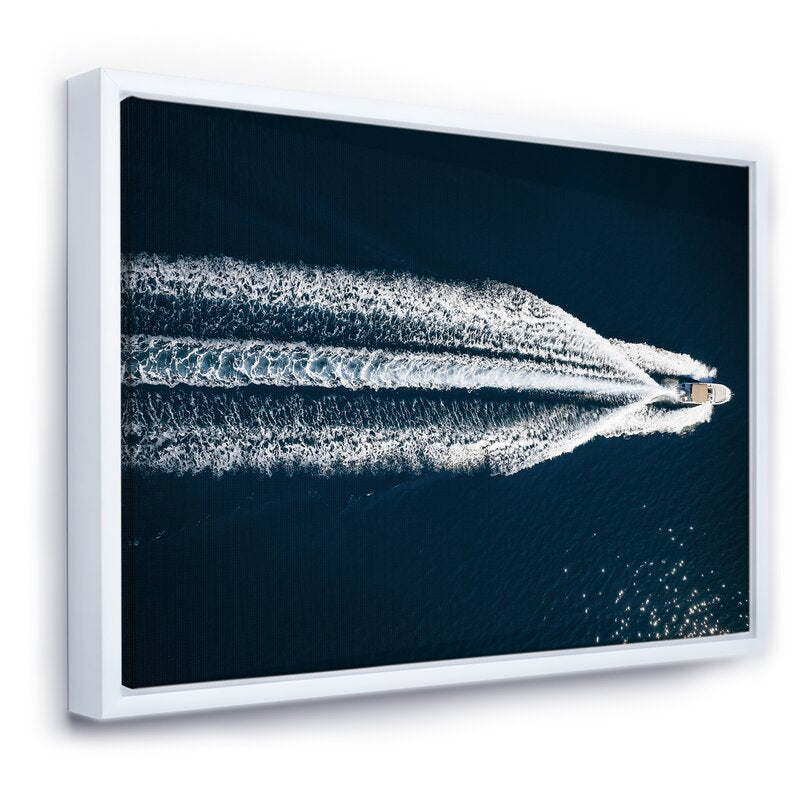 Serene Aerial View of a Speedboat Gliding Across the Mediterranean Waters