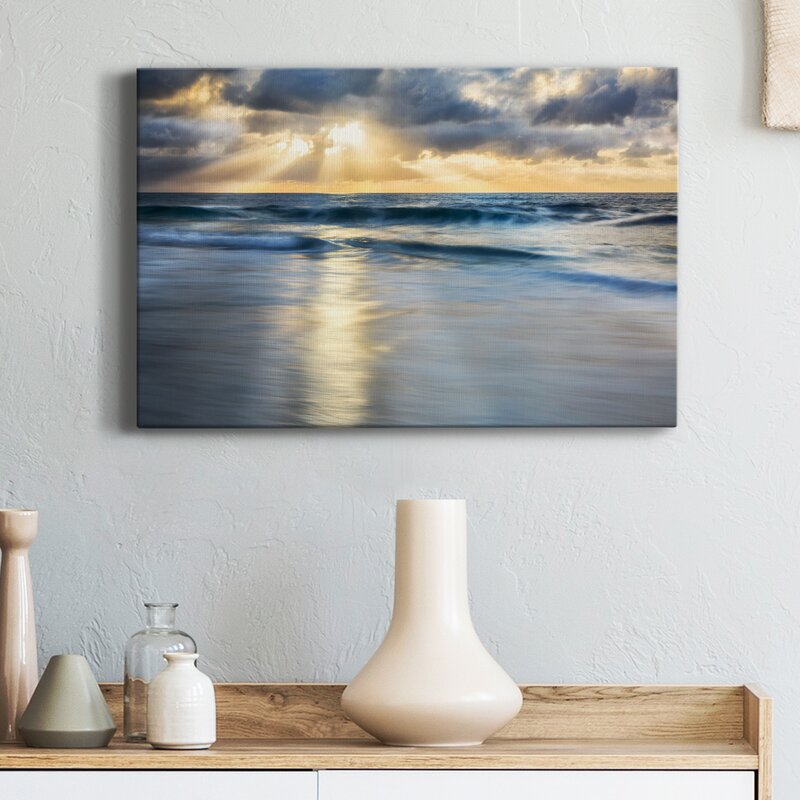 Tranquil Shoreline: Serene Ocean Waves Under a Dramatic Cloudscape