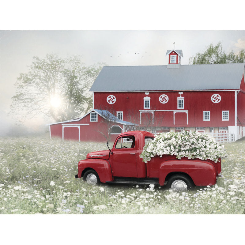 Charming Red Truck with Flowers Against a Rustic Barn Landscape