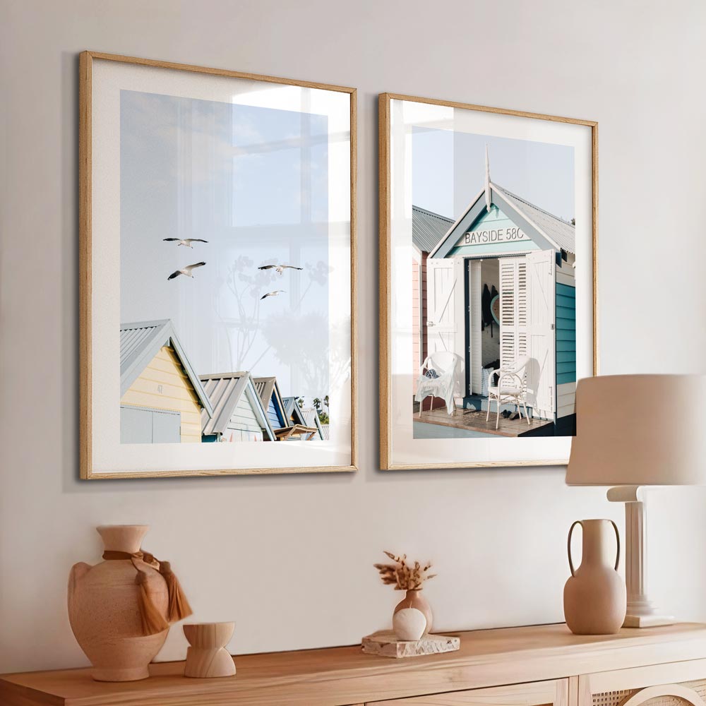 Tranquil Brighton Beach Scene with Soaring Seagulls and Vibrant Beach Huts