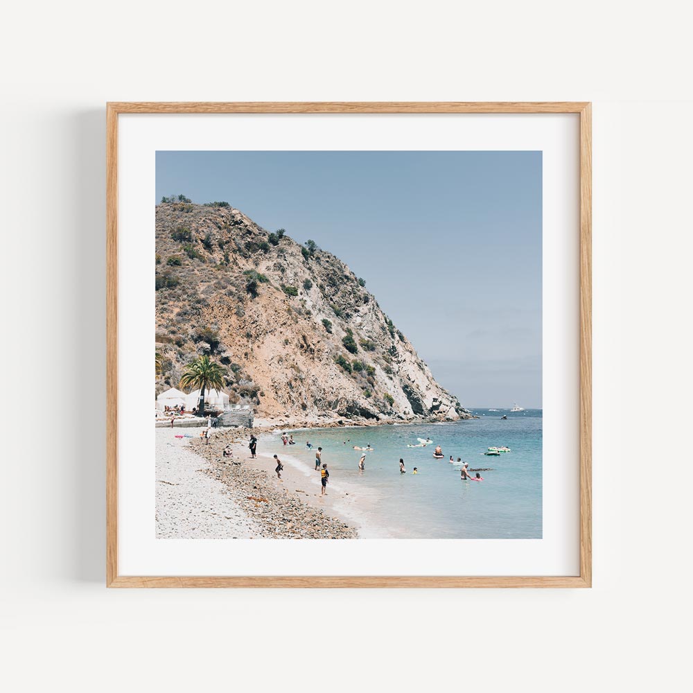 Tranquil Beach Scene with Sunbathers and Clear Waters