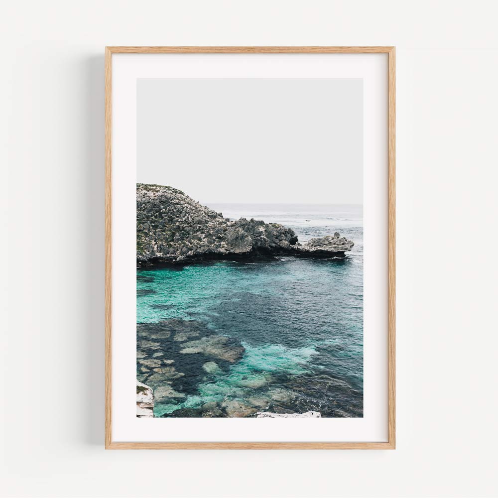 Serene Coastal View with Crystal Clear Water and Lush Greenery