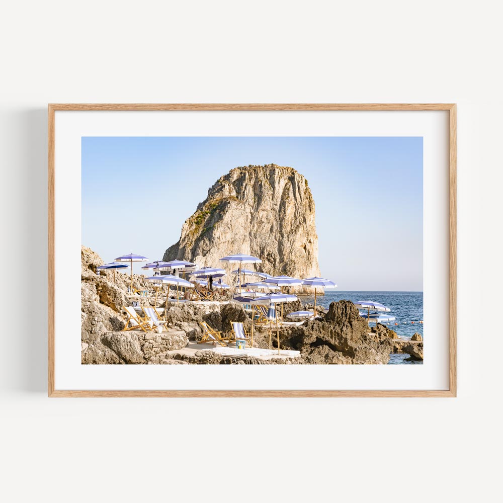 Serene Coastal Escape: Majestic Rock and Beach Loungers Oil Painting