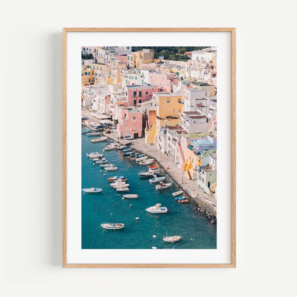 Vibrant Coastal Scene of Procida with Colorful Houses and Boats on Blue Water