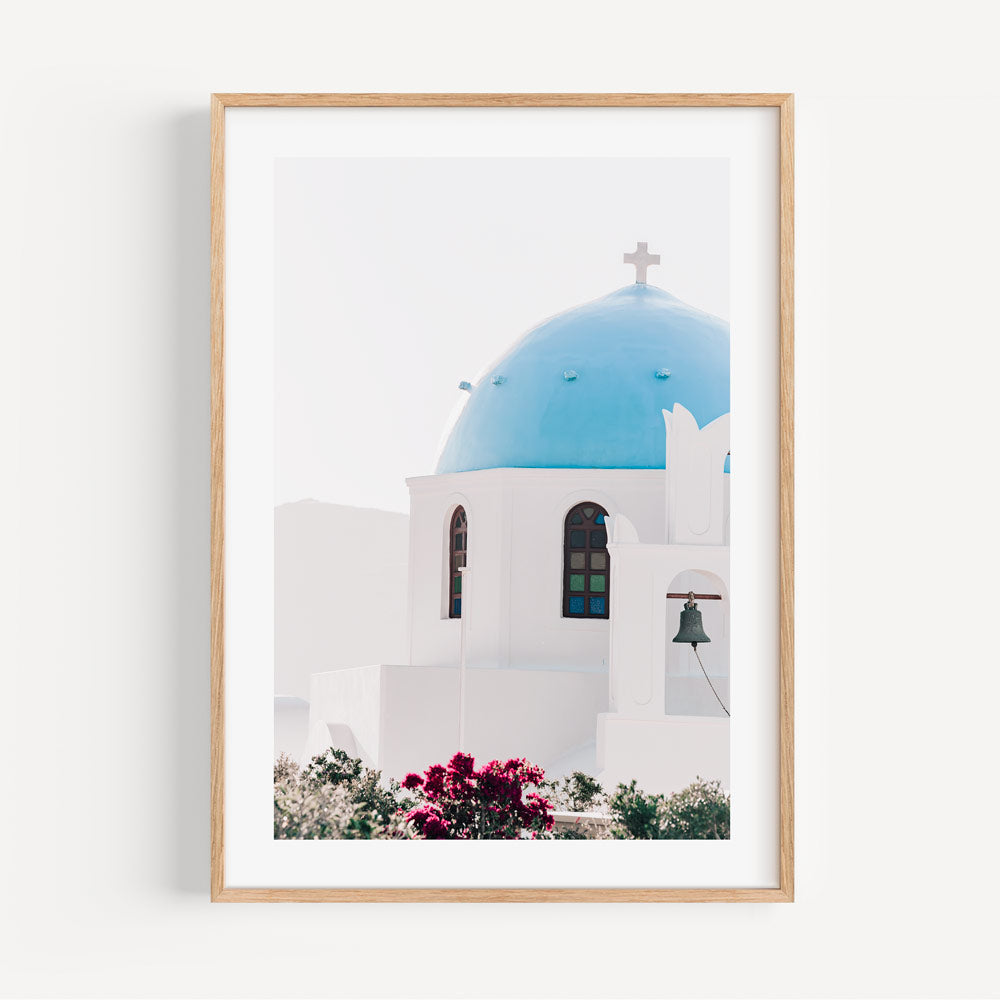 Serene Mediterranean Church with Blue Dome and Vibrant Flowers