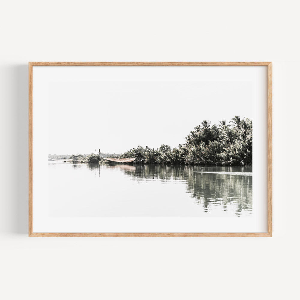 Tranquil Riverbank Landscape with Lush Palm Trees and Serene Waters
