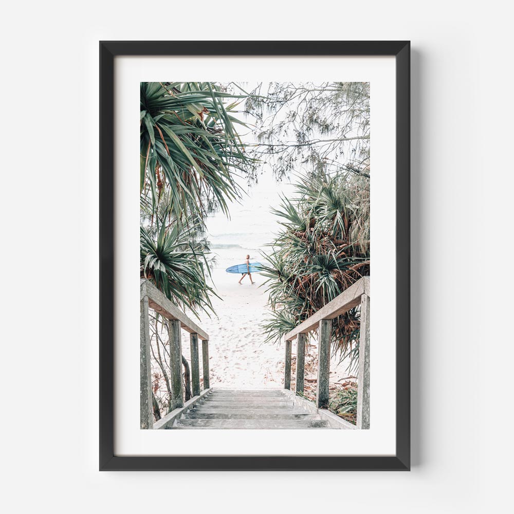 Coastal Serenity: Surfer Strolling Down Tropical Beach Path