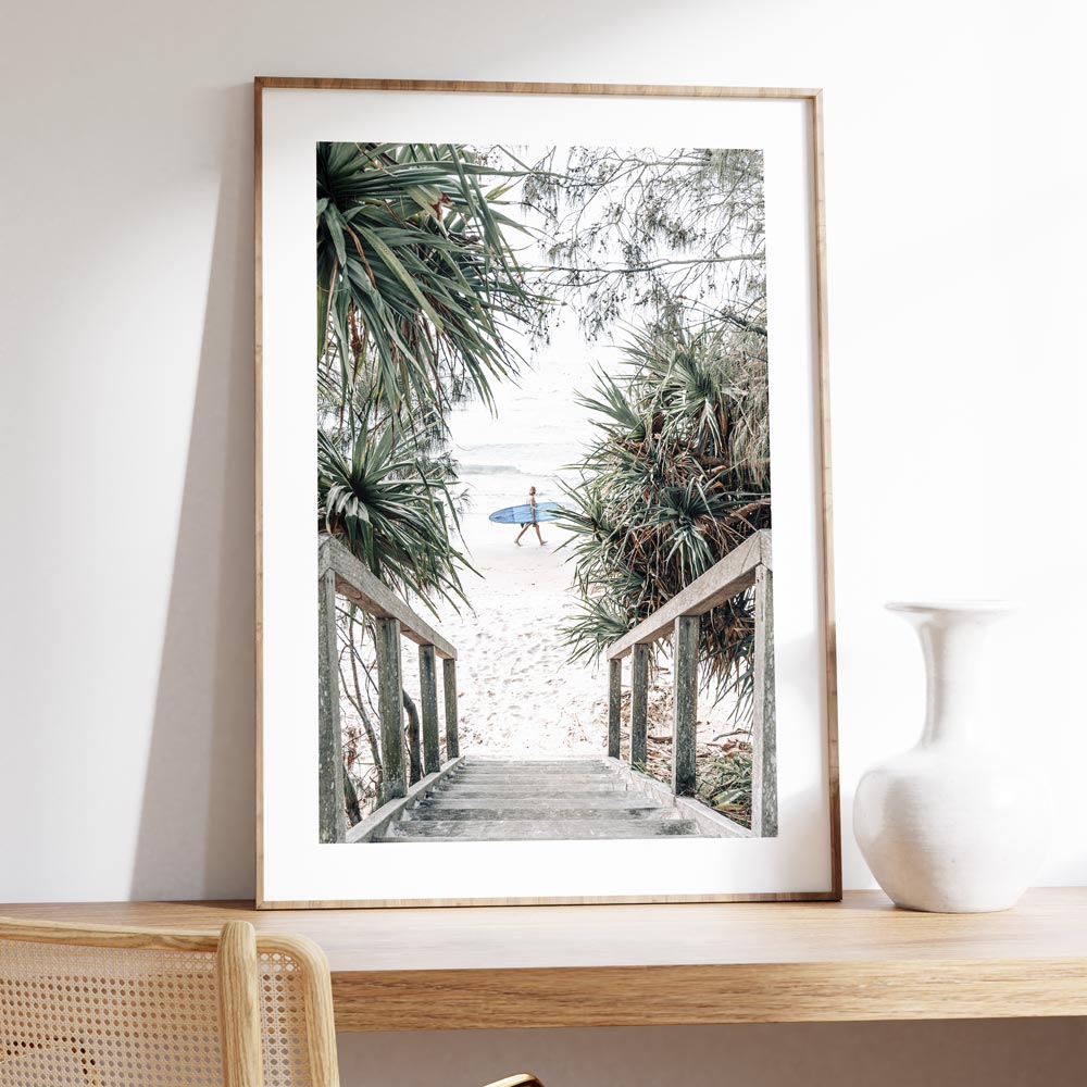 Coastal Serenity: Surfer Strolling Down Tropical Beach Path