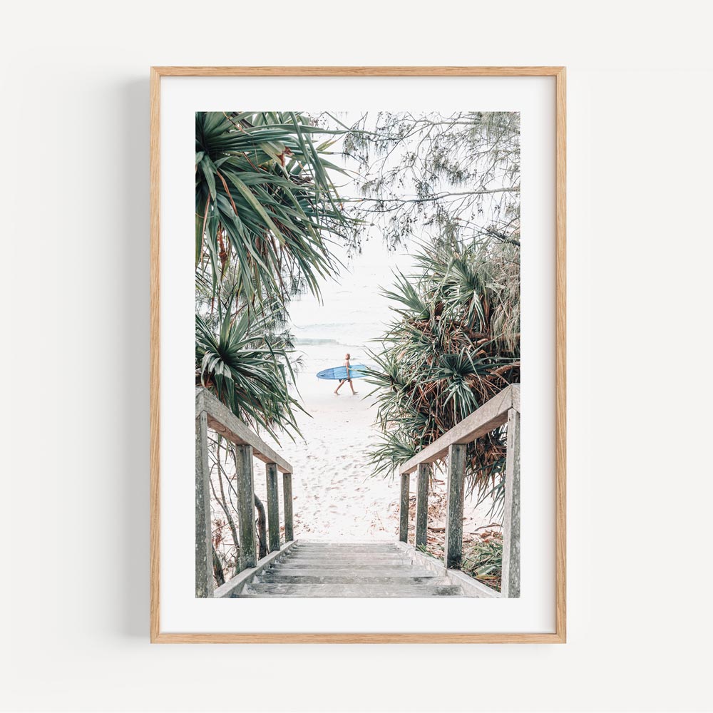 Coastal Serenity: Surfer Strolling Down Tropical Beach Path