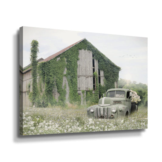 Abandoned Green Truck Amidst Overgrown Barn and Wildflowers
