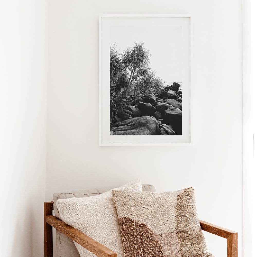 Serene Coastal Landscape with Black Rocks and Lush Tropical Foliage