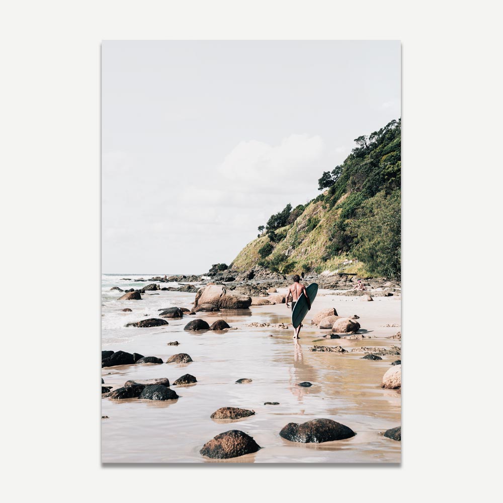 Serene Beach Adventure: Coastal Surfer Walking Along Rocky Shoreline