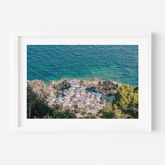 Serene Capri Beach Scene with Coastal Umbrellas and Azure Waters