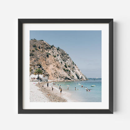 Tranquil Beach Scene with Sunbathers and Clear Waters