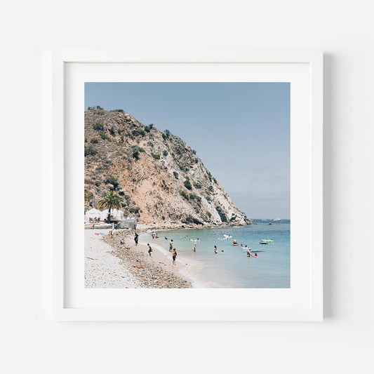 Tranquil Beach Scene with Sunbathers and Clear Waters