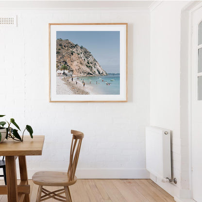 Tranquil Beach Scene with Sunbathers and Clear Waters