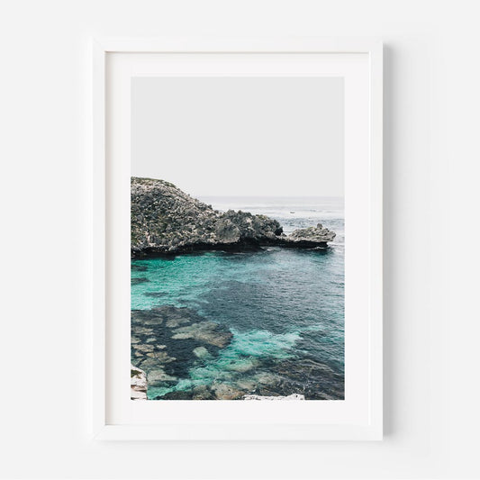 Serene Coastal View with Crystal Clear Water and Lush Greenery