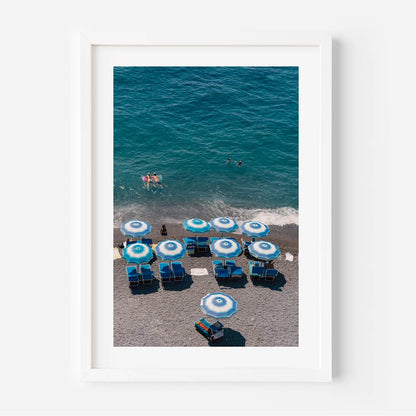 Vibrant Beach Scene with Blue Umbrellas and Swimmers