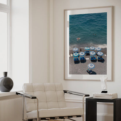 Vibrant Beach Scene with Blue Umbrellas and Swimmers