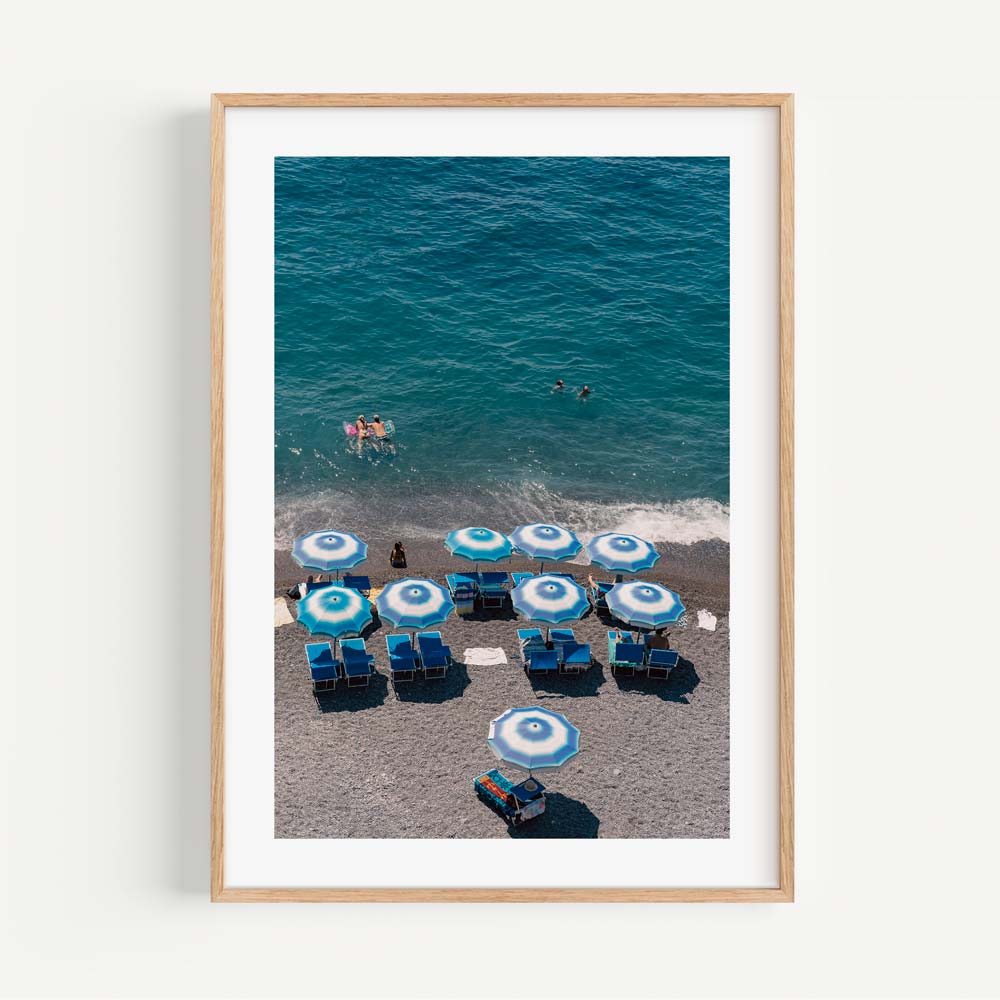 Vibrant Beach Scene with Blue Umbrellas and Swimmers