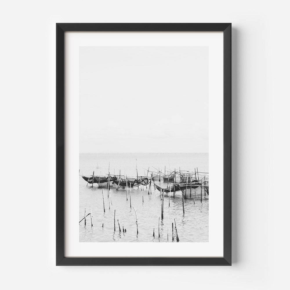 Serene Coastal Scene: Black and White Fishing Boats Reflected in Tranquil Waters
