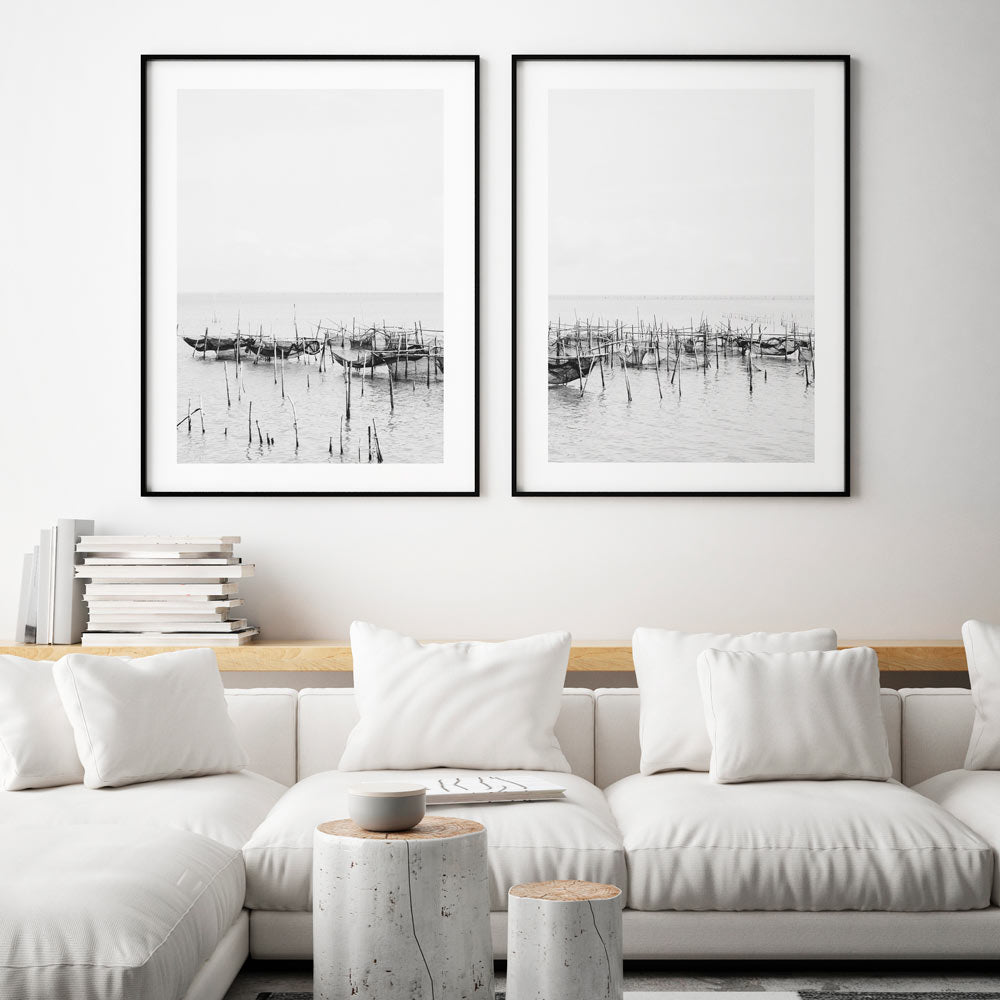 Serene Coastal Scene: Black and White Fishing Boats Reflected in Tranquil Waters