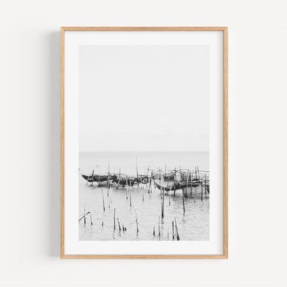 Serene Coastal Scene: Black and White Fishing Boats Reflected in Tranquil Waters