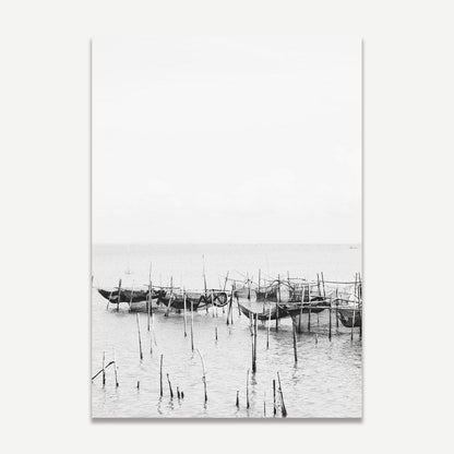 Serene Coastal Scene: Black and White Fishing Boats Reflected in Tranquil Waters