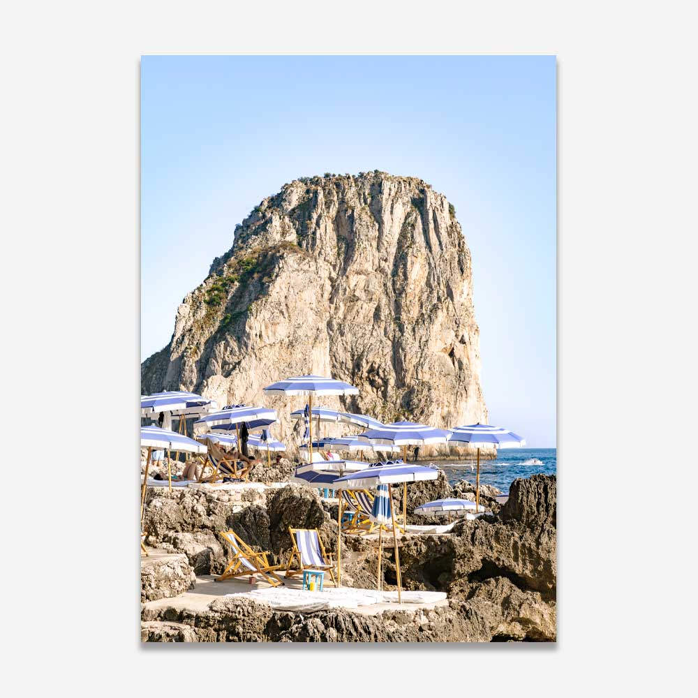 Serene Coastal Escape with Umbrellas and Rocky Cliff in Tranquil Seascape