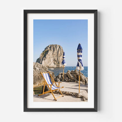 Charming Coastal Retreat: Serene Beach Scene with Umbrellas and Rock Formation
