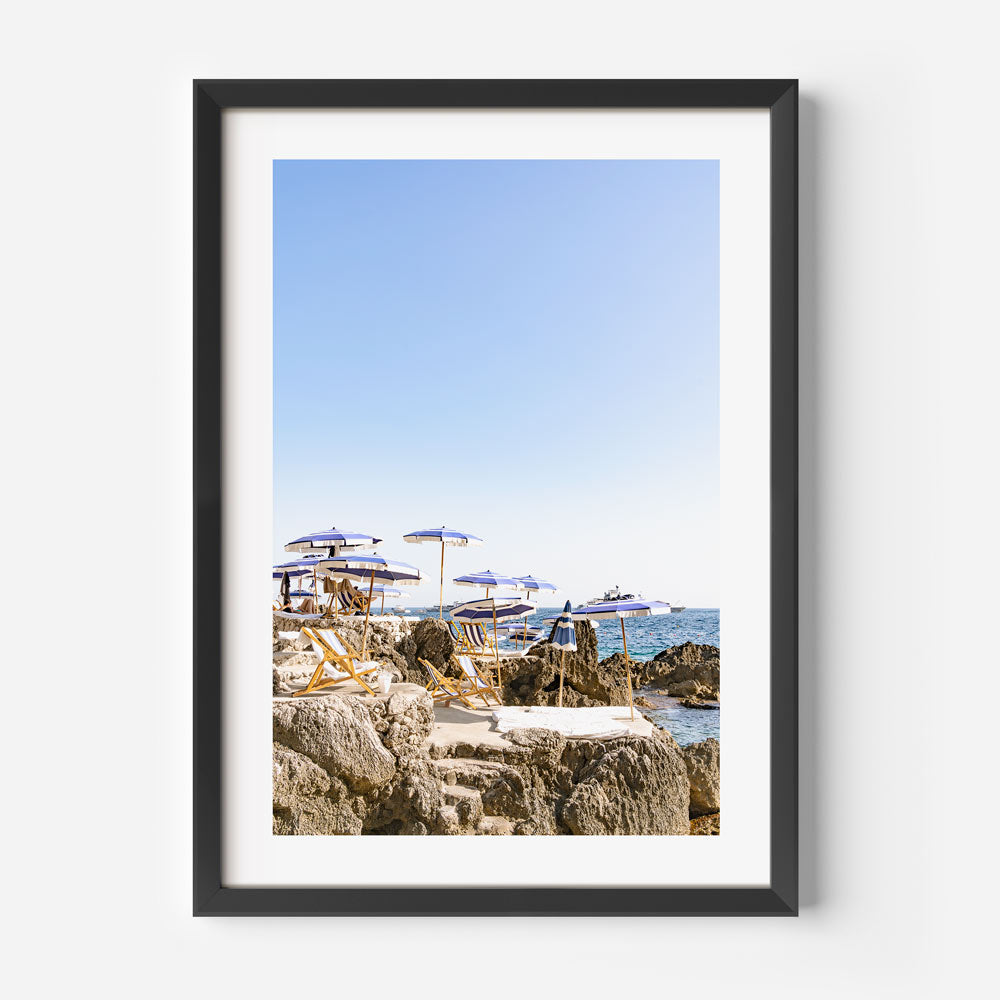 Serene Coastal Escape with Umbrellas and Rock Formations