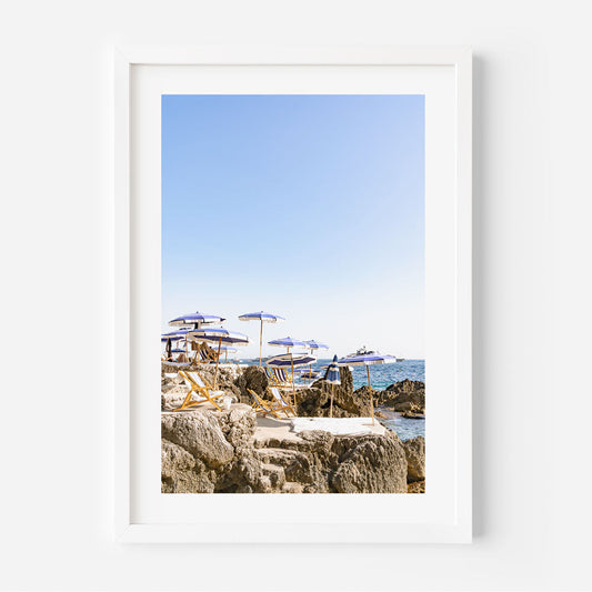 Serene Coastal Escape with Umbrellas and Rock Formations