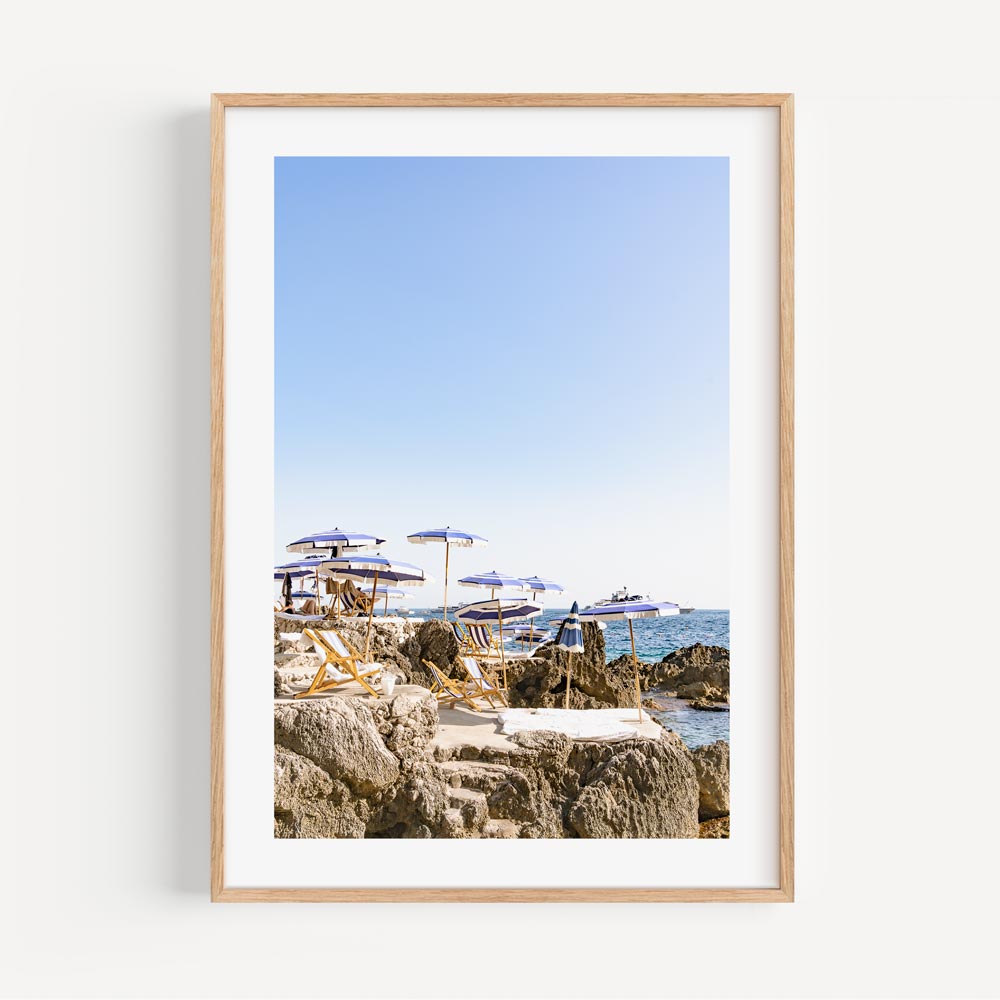 Serene Coastal Escape with Umbrellas and Rock Formations