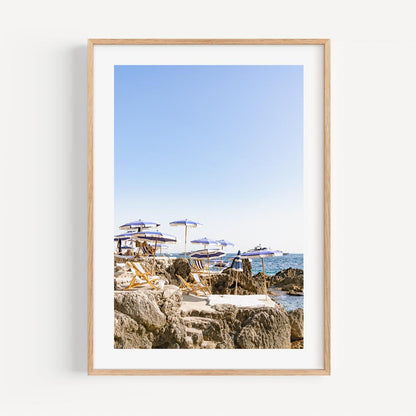 Serene Coastal Escape with Umbrellas and Rock Formations