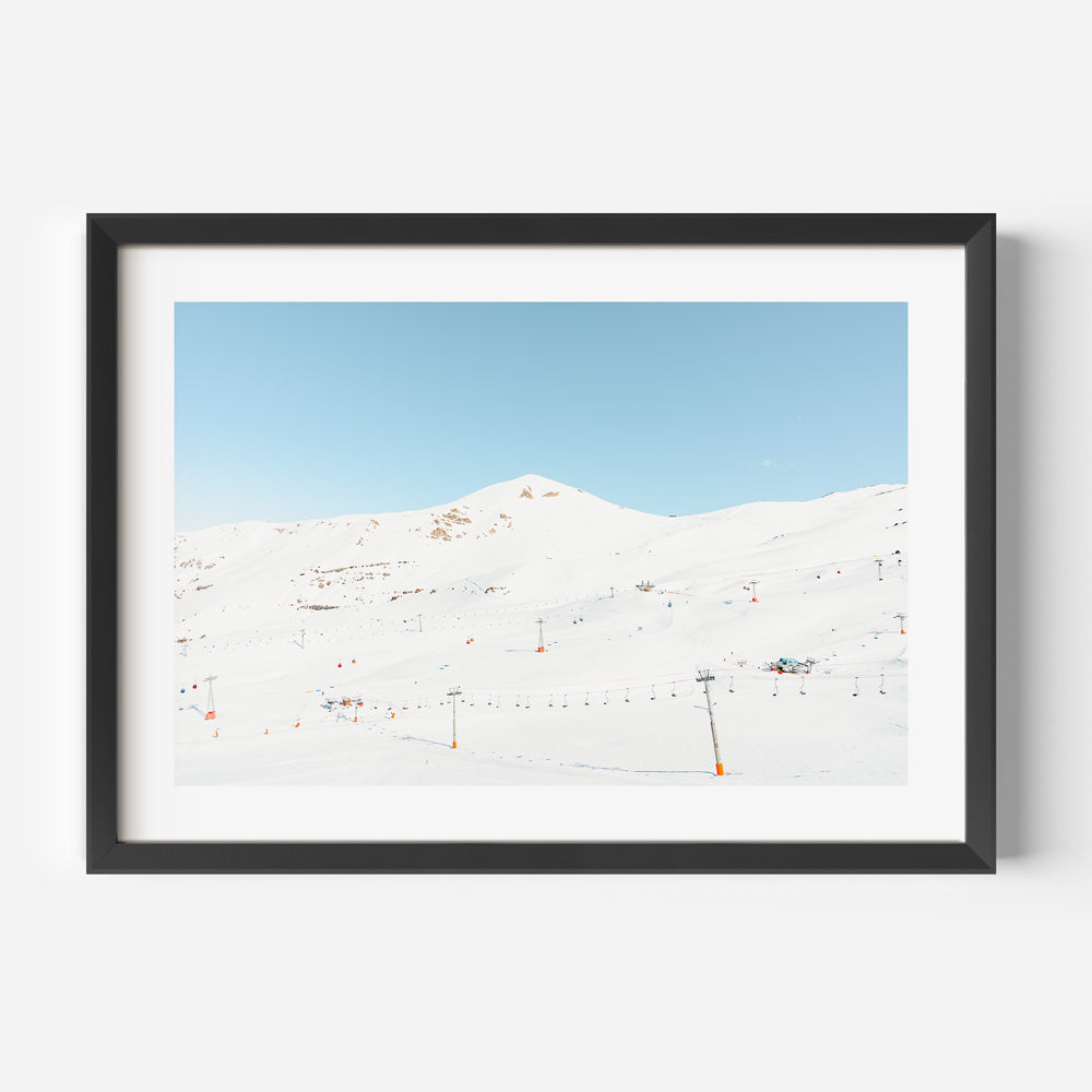 Serene Winter Landscape with Ski Lifts and Snow-Covered Mountains