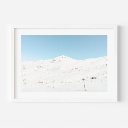 Serene Winter Landscape with Ski Lifts and Snow-Covered Mountains