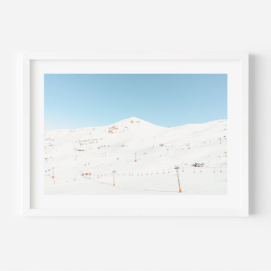 Serene Winter Landscape with Ski Lifts and Snow-Covered Mountains