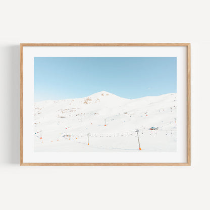 Serene Winter Landscape with Ski Lifts and Snow-Covered Mountains