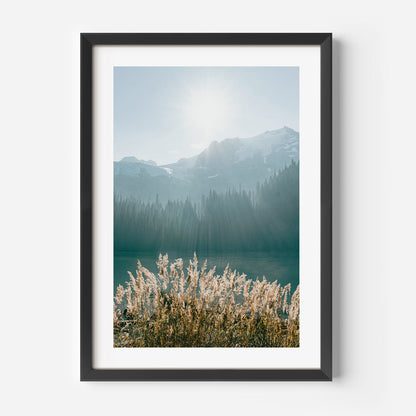 Serene Mountain Lake Landscape with Glowing Sun and Lush Wild Grasses