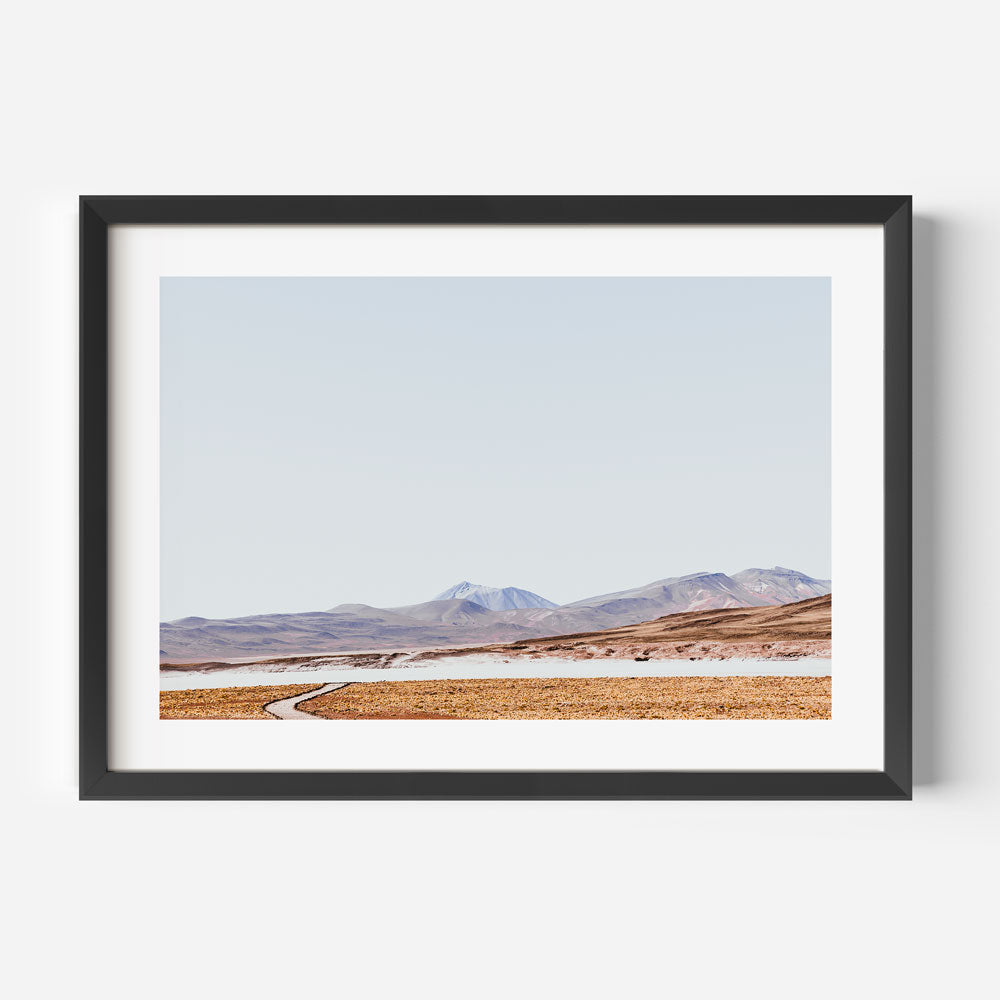 Tranquil Rocky Landscape with Meandering Path and Majestic Mountains