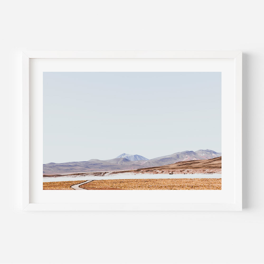 Tranquil Rocky Landscape with Meandering Path and Majestic Mountains