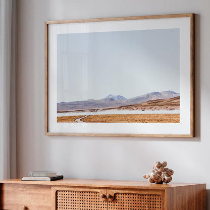 Tranquil Rocky Landscape with Meandering Path and Majestic Mountains