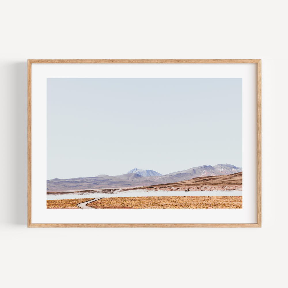 Tranquil Rocky Landscape with Meandering Path and Majestic Mountains