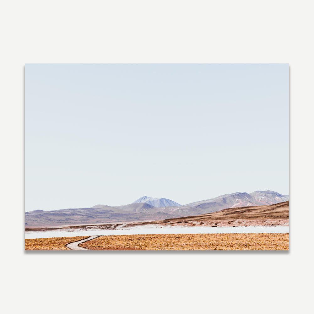 Tranquil Rocky Landscape with Meandering Path and Majestic Mountains