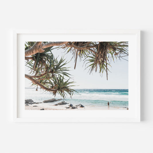 Tranquil Coastal Scene with Tropical Trees and Serene Ocean Waves