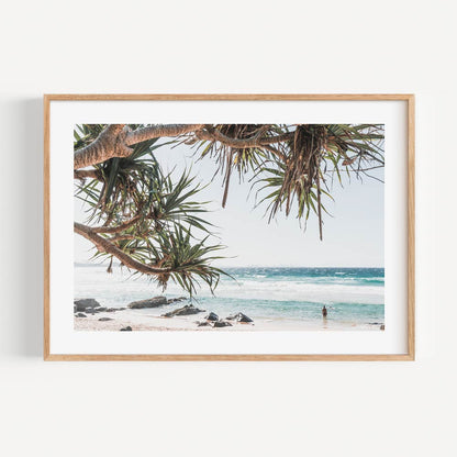 Tranquil Coastal Scene with Tropical Trees and Serene Ocean Waves