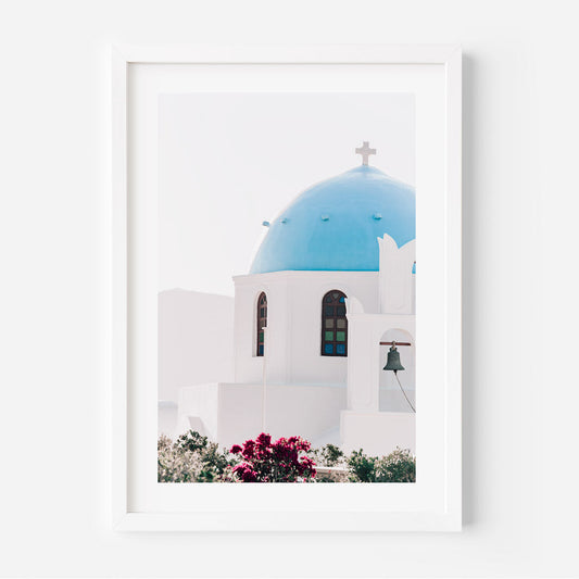 Serene Mediterranean Church with Blue Dome and Vibrant Flowers