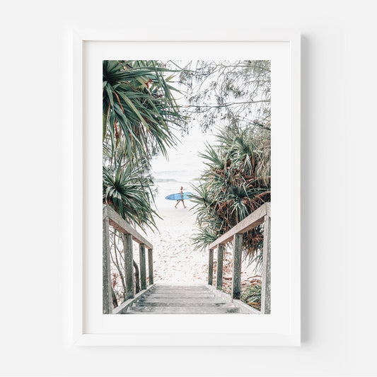 Coastal Serenity: Surfer Strolling Down Tropical Beach Path
