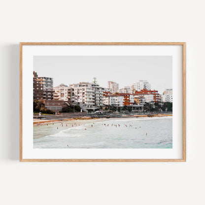 Serene Cronulla Beach Scene with Coastal Waves and Urban Skyline